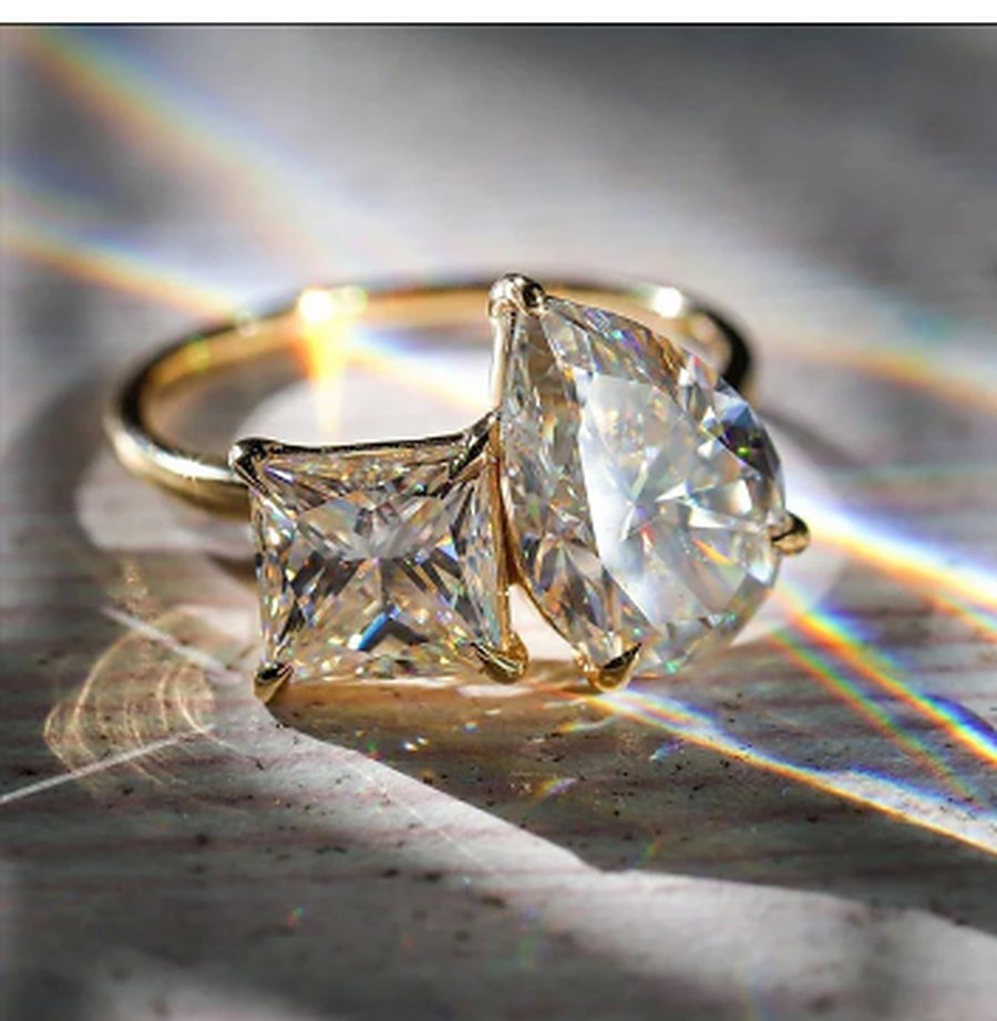 Moissanite two stone ring showing prismatic fire and dispersion in sunlight
